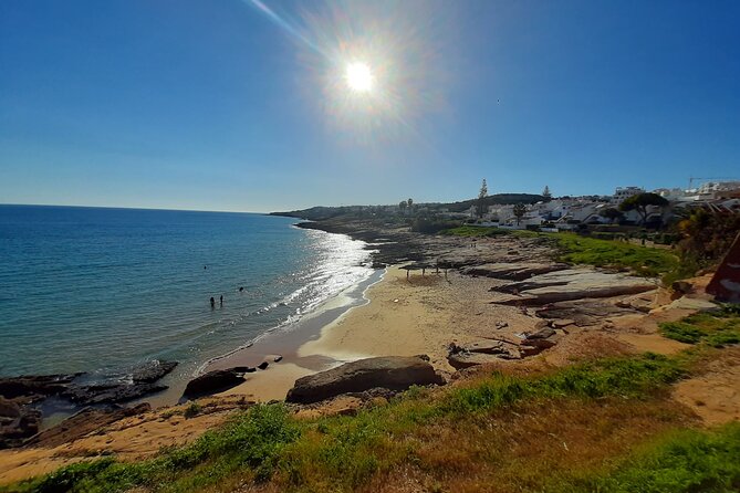 Lagos to Luz with an eco Tuk and local guide - Stop at Praia da Luz: cliffs, arches, and volcanic rock in 10 minutes